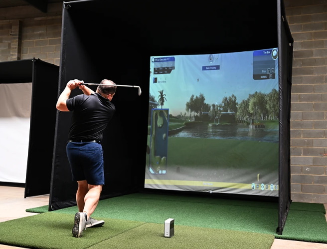 How does an indoor golf bay differ from an outdoor one"